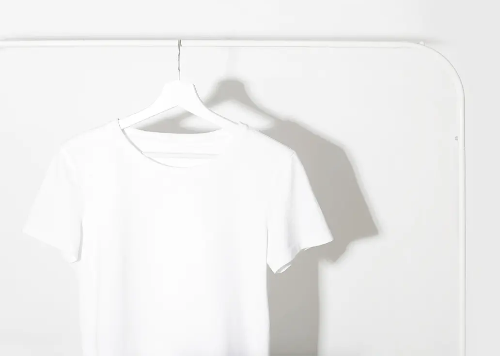 A white t-shirt hanging on the wall.