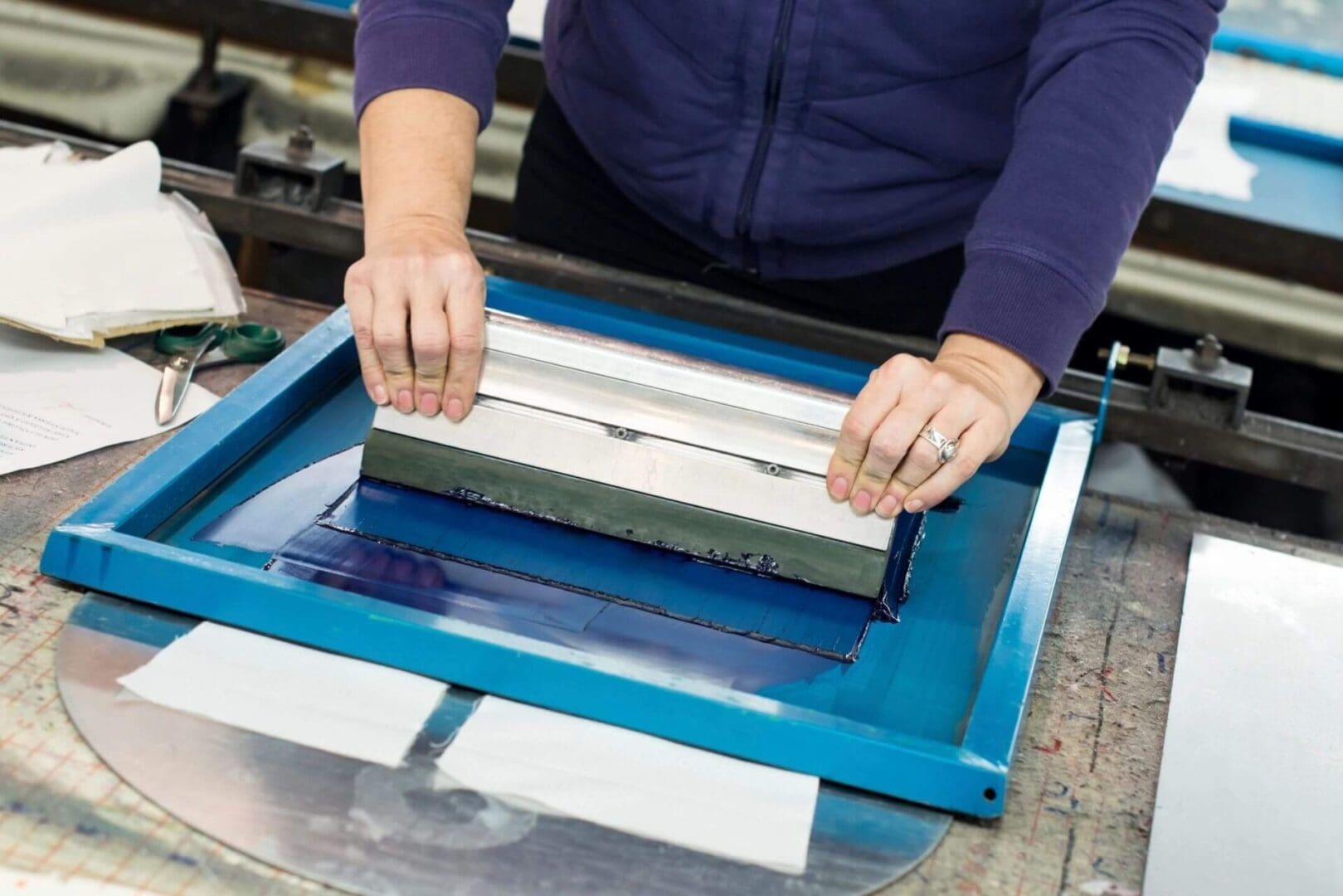 A person is using a screen to print.